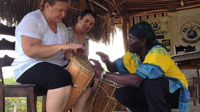 Sunset under the Ceiba Tree with Live Drumming Overwater.